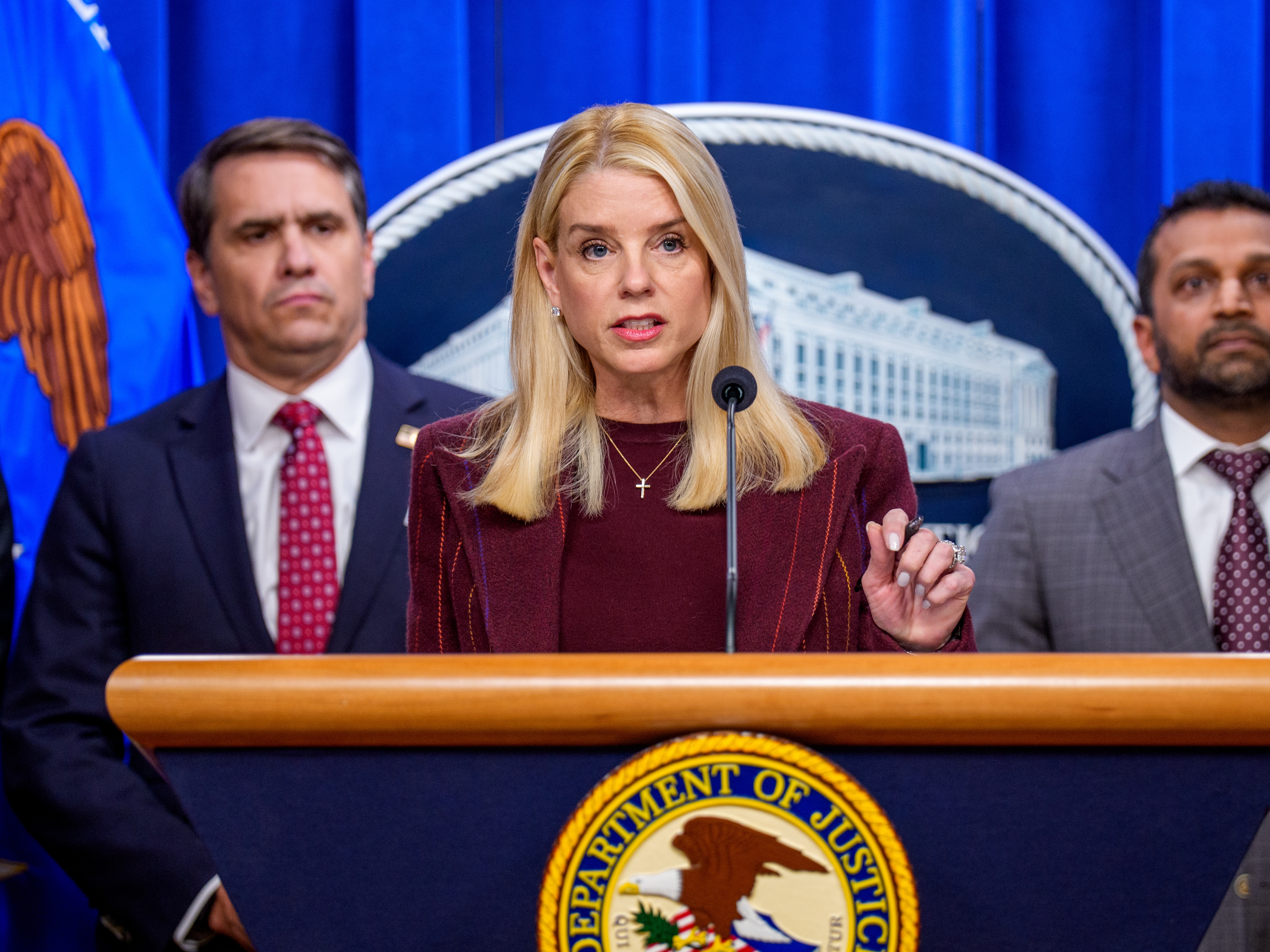 caption: Attorney General Pam Bondi, accompanied by Deputy Attorney General Todd Blanche (L) and FBI Director Kash Patel (R), speaks during a news conference at the Justice Department on Nov. 19. Some lawmakers said the department's release of files relating to Jeffrey Epstein had too many redactions as well as missing information.