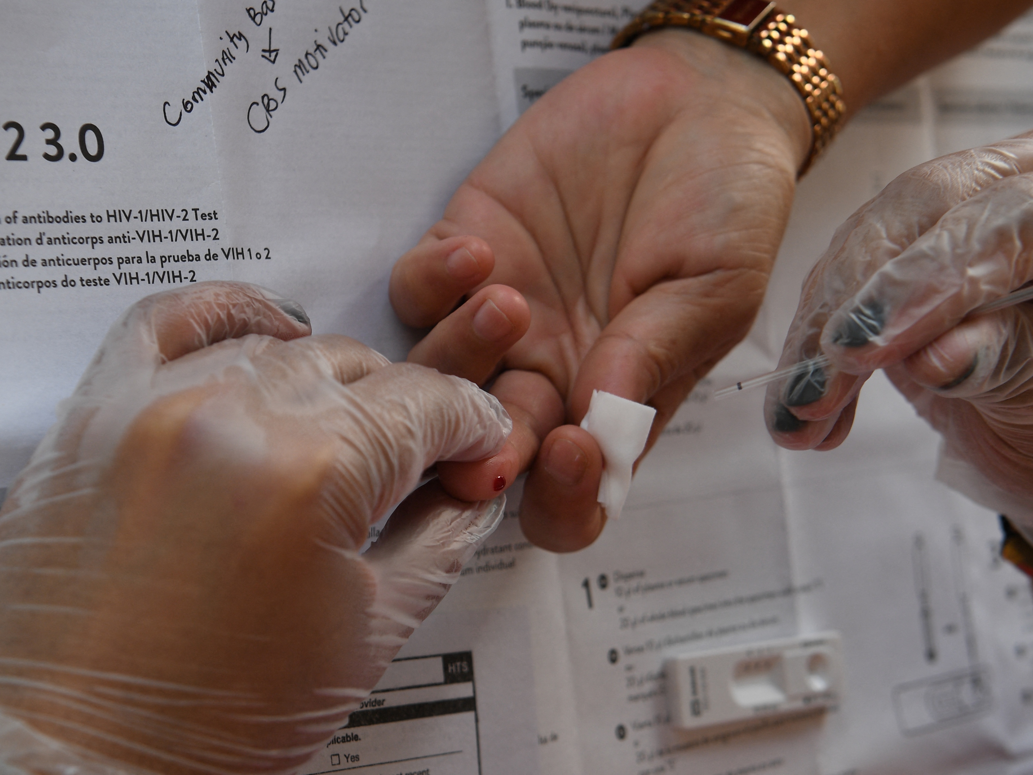 caption: A woman in Manila gets blood drawn for an HIV test. HIV infections are soaring in the Philippines. Health specialists blame a lack of sex education and the stigma associated with visiting an HIV clinic in this deeply religious country.
