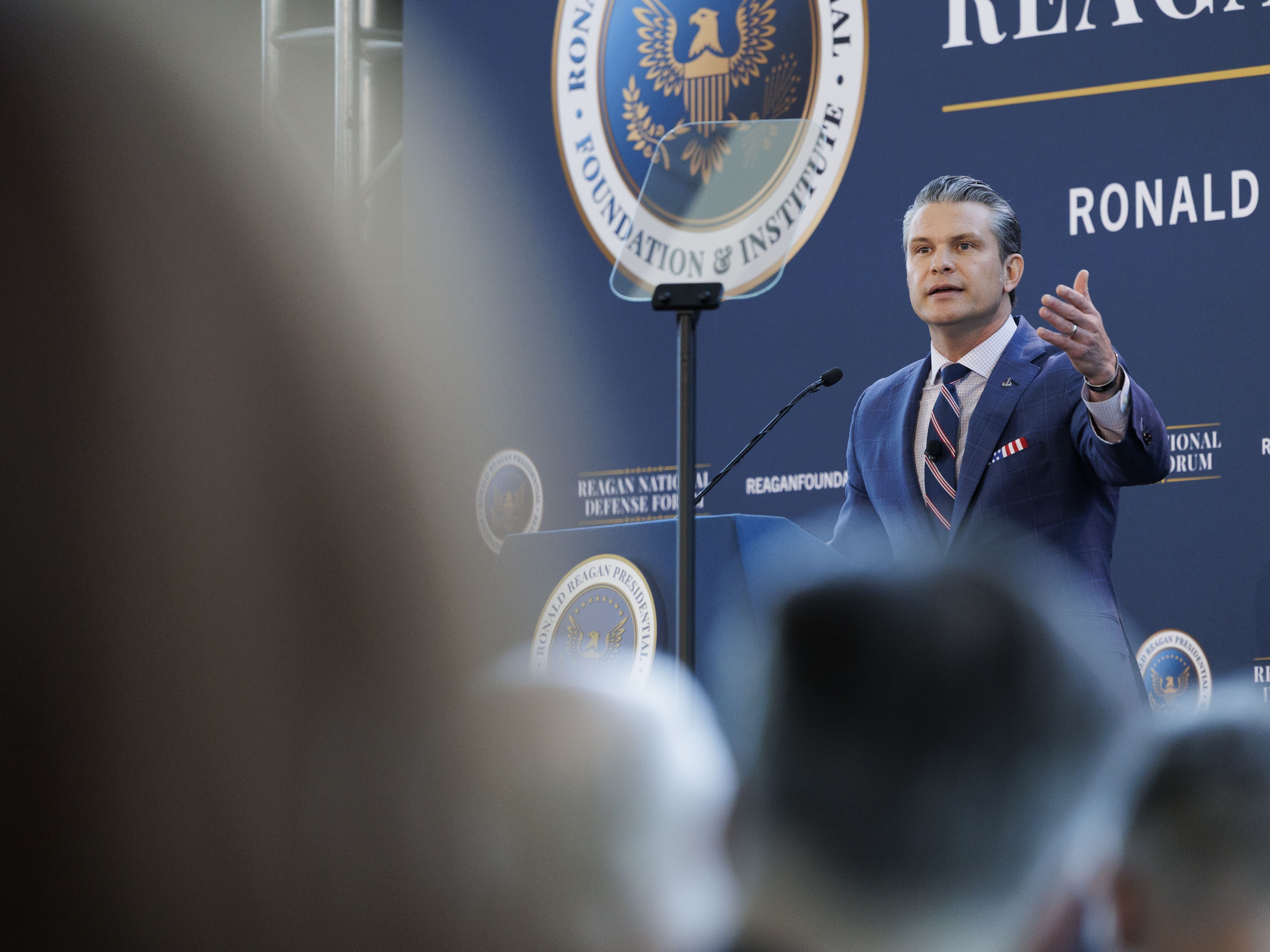 caption: Defense Secretary Pete Hegseth speaks at the Reagan National Defense Forum at the Ronald Reagan Presidential Library in Simi Valley, California, on Saturday.