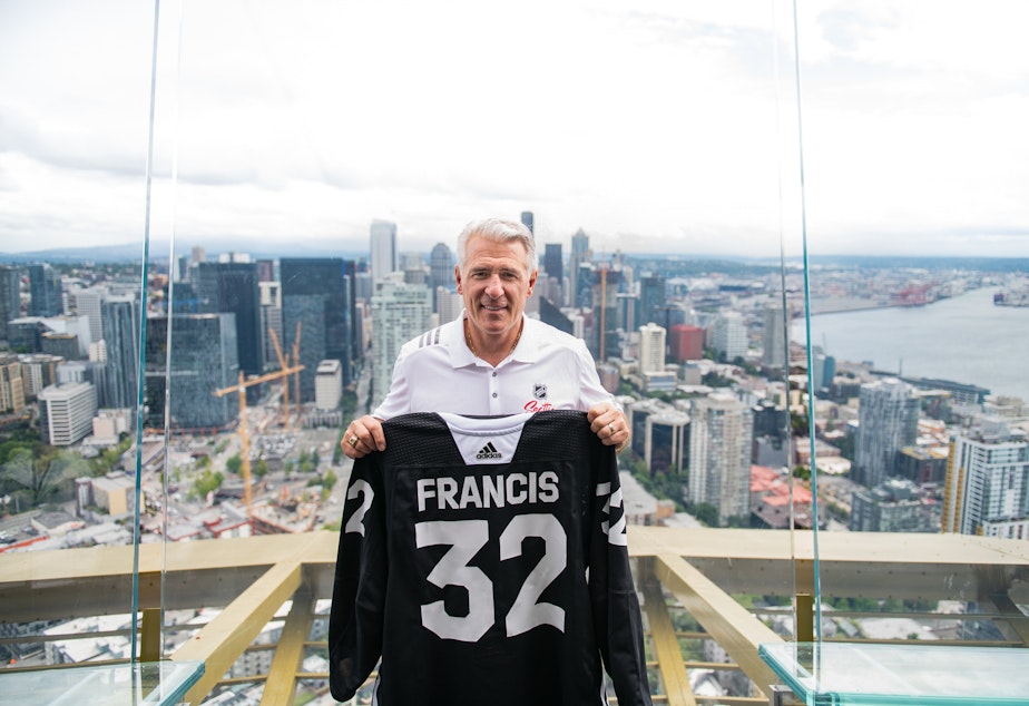 caption: Ron Francis, the new general manager of Seattle's NHL team, stands atop the Space Needle