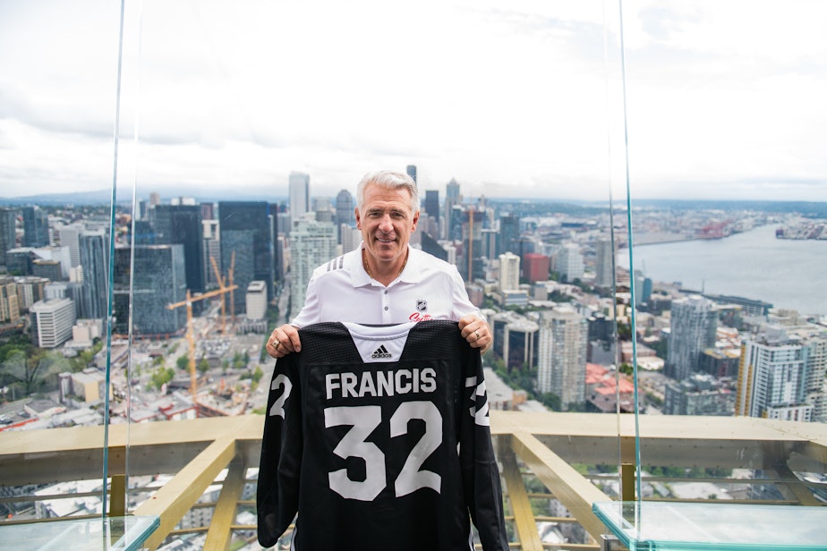 caption: Ron Francis, the new general manager of Seattle's NHL team, stands atop the Space Needle
