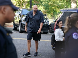 caption: Sen. John Fetterman, D-Pa., arrives at the Russell Senate Office Building last Wednesday. The Senate's unwritten dress code will no longer be enforced as of this week.