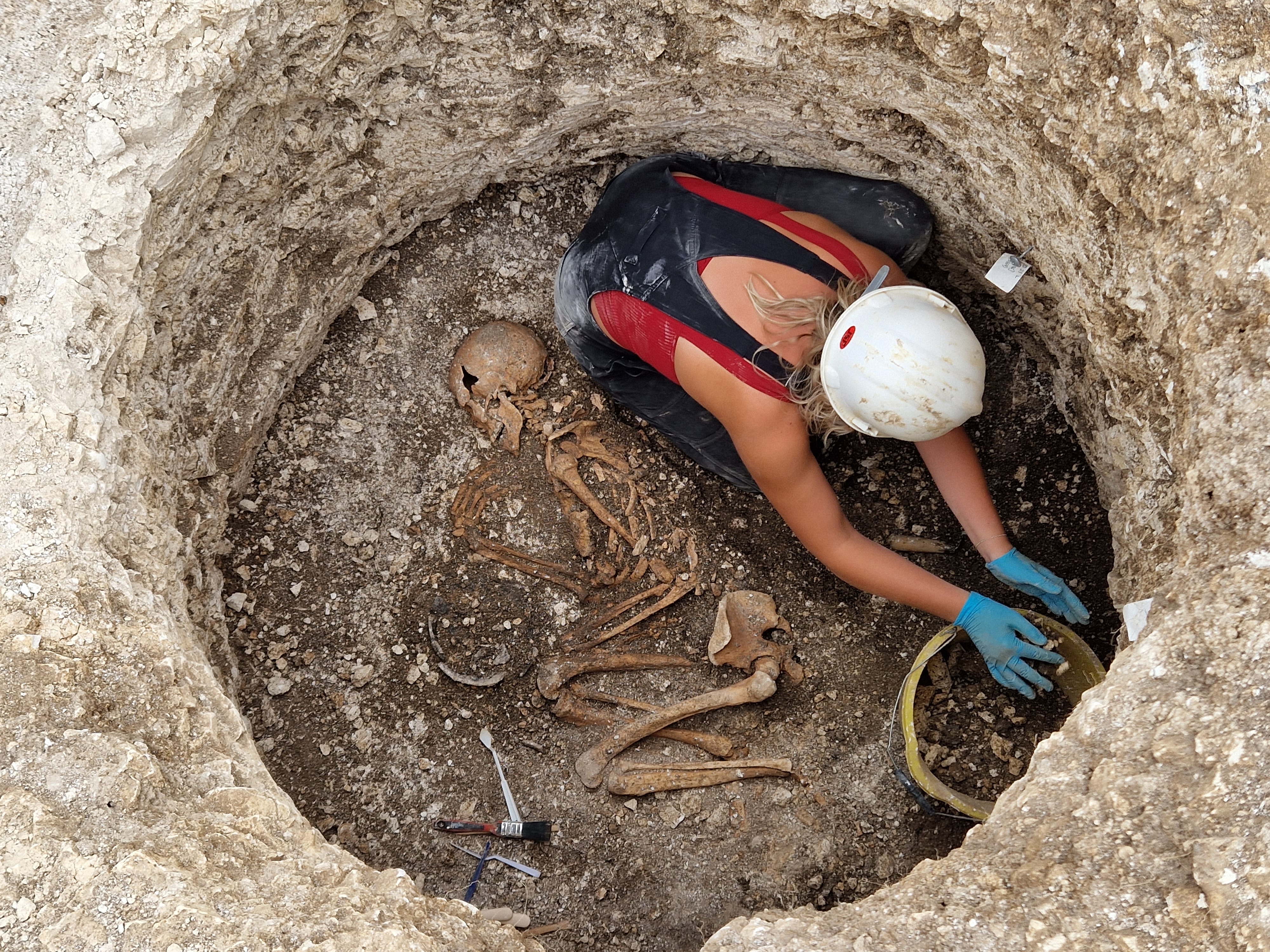 caption: Excavating a Late Iron Age Durotriges burial at Winterborne Kingston