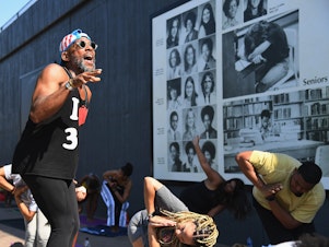 caption: Marlon F. Hall leads a yoga class next to Interstate 244, which runs through the Tulsa neighborhood of Greenwood, the location of the <a href="https://www.npr.org/series/1001433852/the-tulsa-race-massacre">Tulsa Race Massacre</a> 100 years ago. Tulsa's celebration of Juneteenth comes less than three weeks after the anniversary.