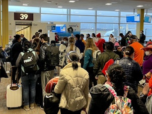 caption: Crowds are seen at Washington's Reagan National Airport on Friday. More than a million people went through airport security each of the past two days, despite the coronavirus pandemic.