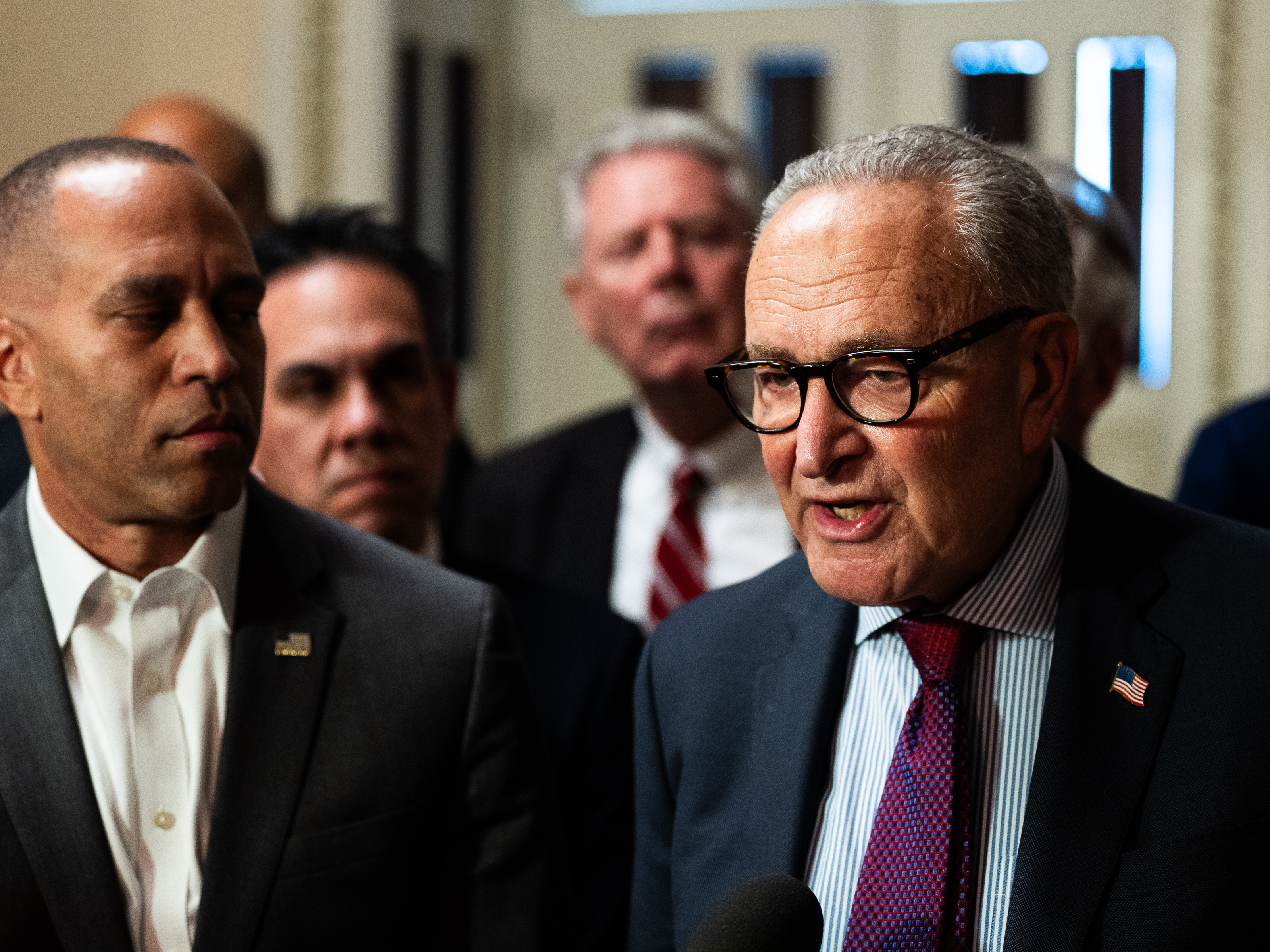 caption: Senate Minority Leader Charles Schumer, right, and House Minority Leader Hakeem Jeffries speak with members of the press on Capitol Hill on Sept. 11. The two New York Democrats are asking President Trump for a meeting before an impending government shutdown.
