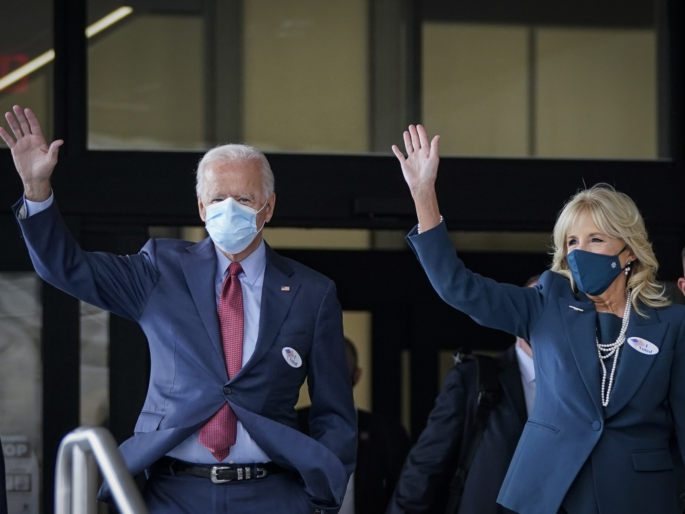 caption: Democratic presidential nominee Joe Biden and his wife, Jill Biden, depart after casting their ballots Wednesday at the Carvel State Office Building in Wilmington, Del.