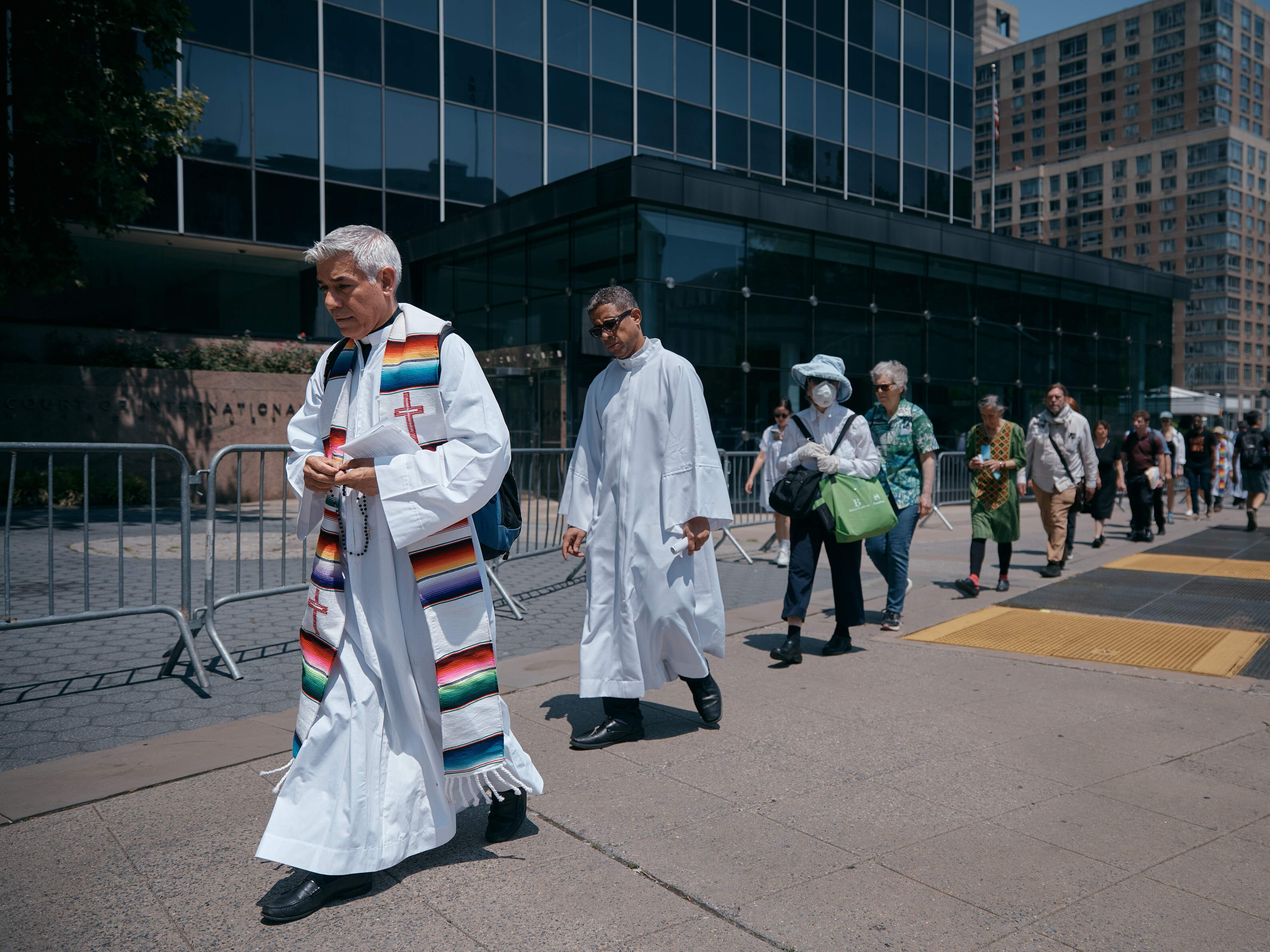 caption: Activists hold a "Jericho Walk" in support of immigrants in front of the Jacob K. Javits Federal Building in June in New York City.