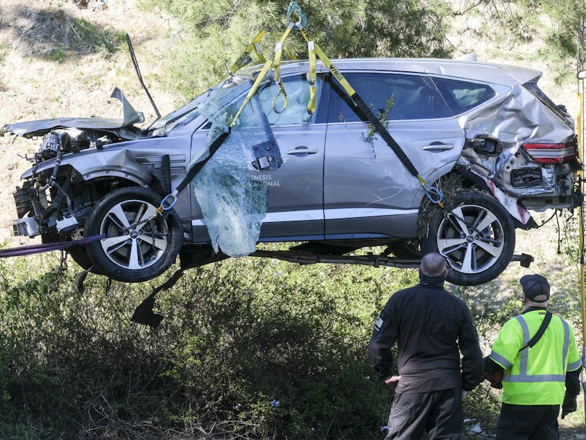 caption: A crane is used to lift a vehicle driven by golfer Tiger Woods following a rollover accident in February in the Rancho Palos Verdes suburb of Los Angeles.