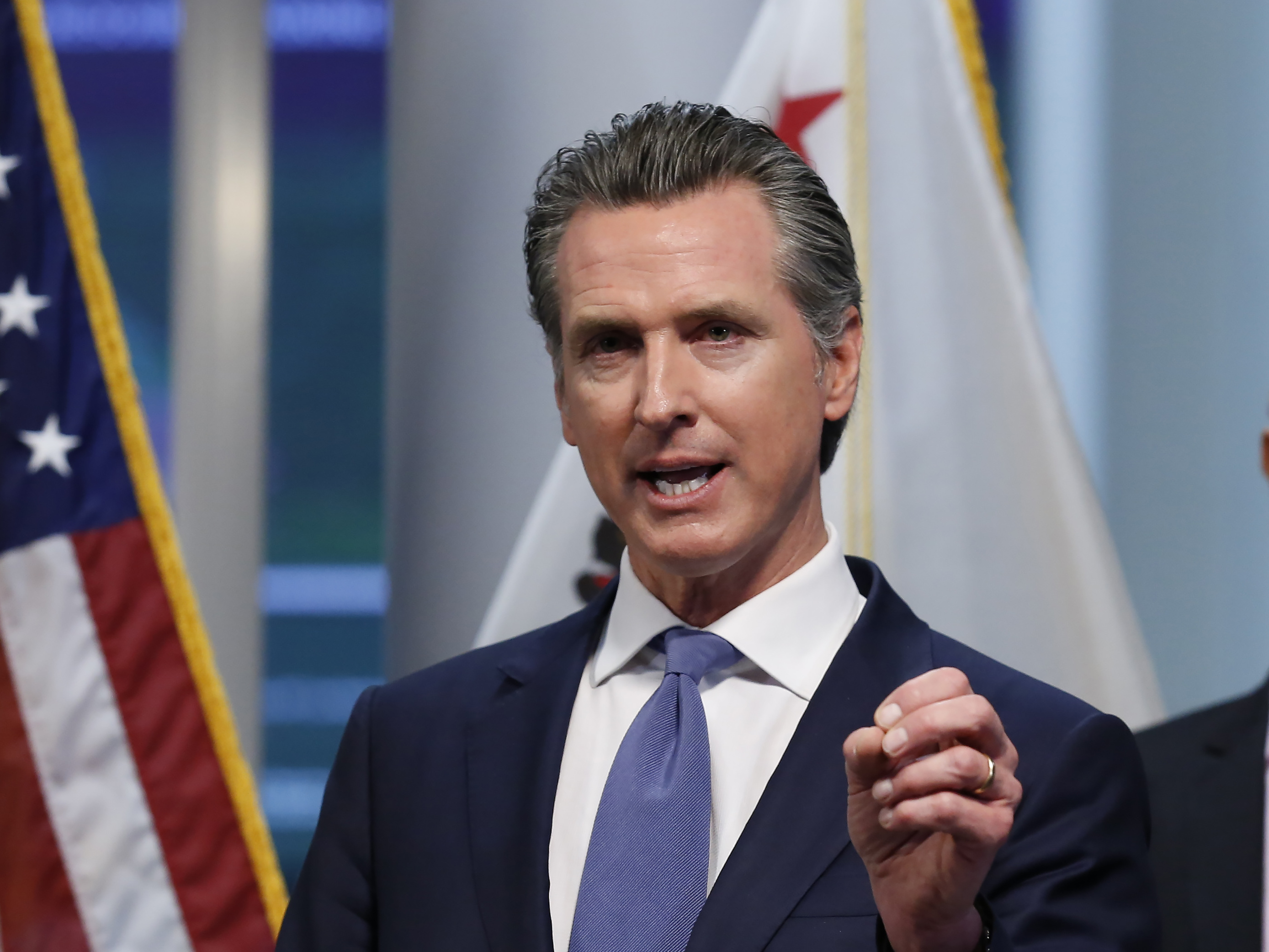 caption: California Gov. Gavin Newsom gives an update to the state's response to the coronavirus, at the Governor's Office of Emergency Services in Rancho Cordova, Calif., on Tuesday.