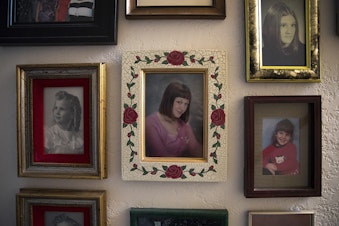 caption: A photograph of Piper Travis, center, hangs on a wall of photographs on Tuesday, January 22, 2019, at Greg and Paulette Beck's home on Whidbey Island. 