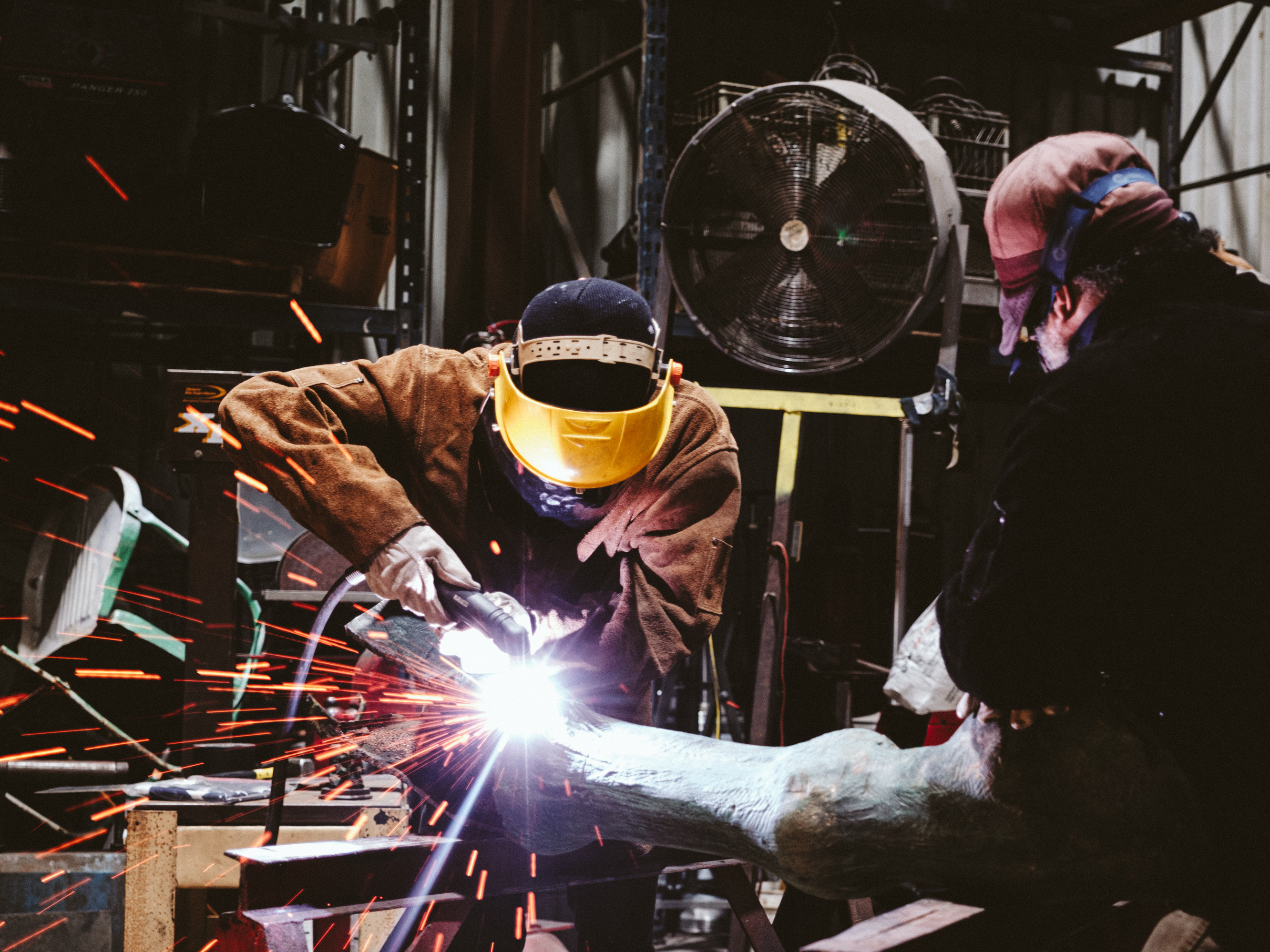 caption: Foundry workers at an undisclosed location begin the long process of disassembling and melting down the statue of Confederate Gen. Robert E. Lee. The statue was a focal point of deadly riots in Charlottesville, Va. in 2017.