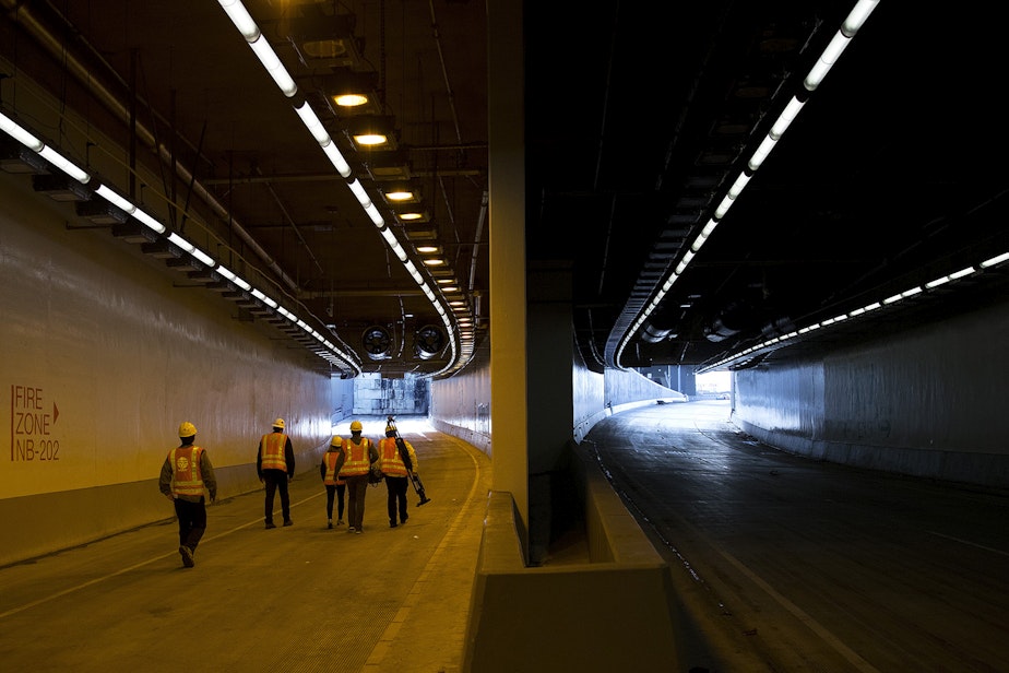caption: Members of the media walk toward the the tunnel's northbound on-ramp, left, on Thursday, November 15, 2018, inside the State Route 99 tunnel in Seattle.