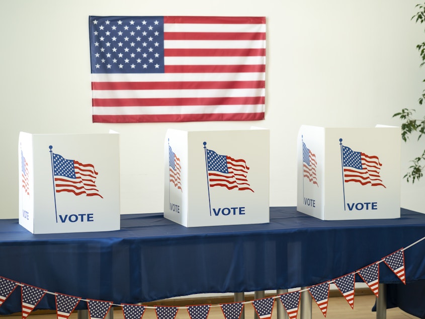 caption: Empty room ready for voting booths for Election Day.