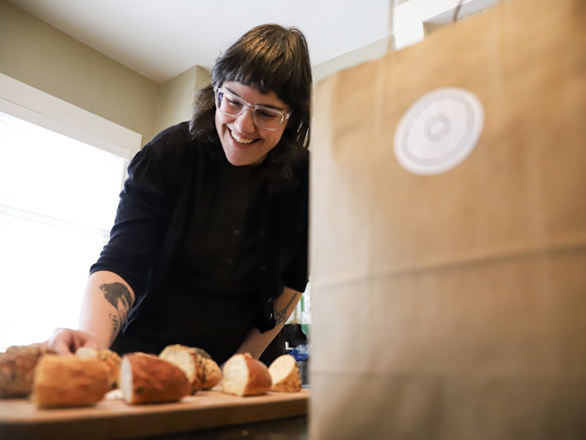 caption: Carrine Fisher gets the 13 pieces of bagels ready to try as part of Bagel Quest on Feb. 17, 2024.