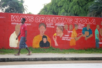 caption: A mural in Liberia warns of Ebola.