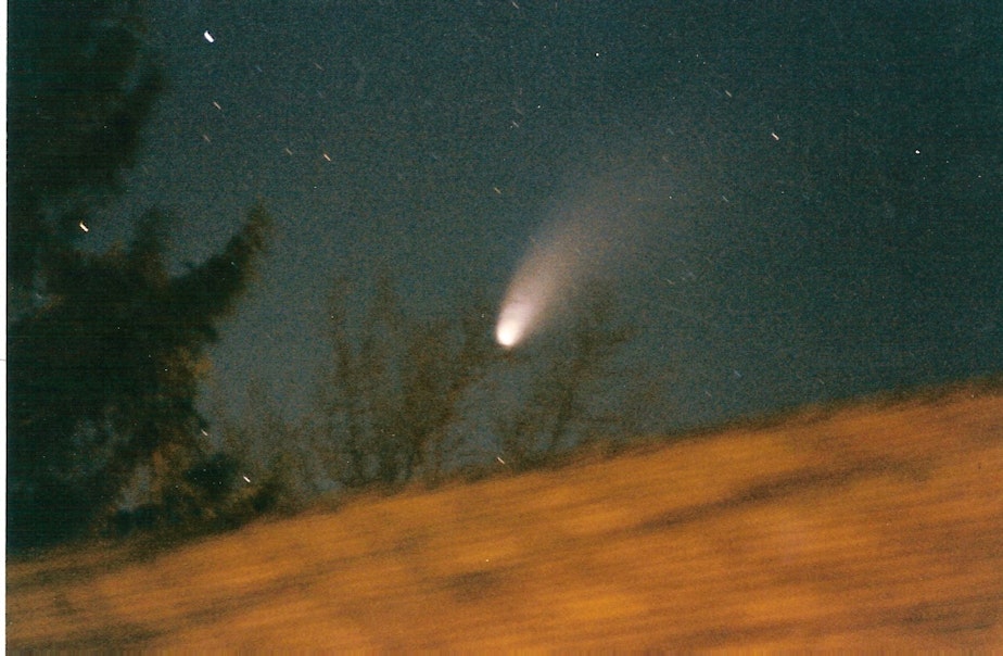 caption: The Hale-Bopp comet passes overhead on March 26, 1997.