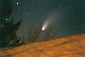 caption: The Hale-Bopp comet passes overhead on March 26, 1997.