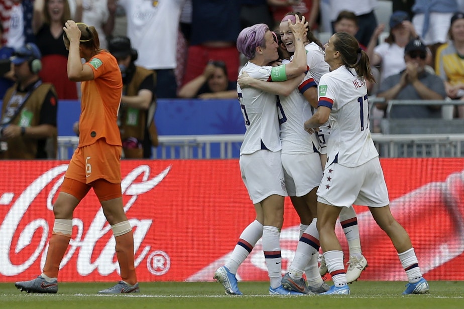 caption: United States' Rose Lavelle, second right, celebrates with Megan Rapinoe, center, after scoring her side's second goal during the Women's World Cup final soccer match between US and The Netherlands at the Stade de Lyon in Decines, outside Lyon, France, Sunday, July 7, 2019. 