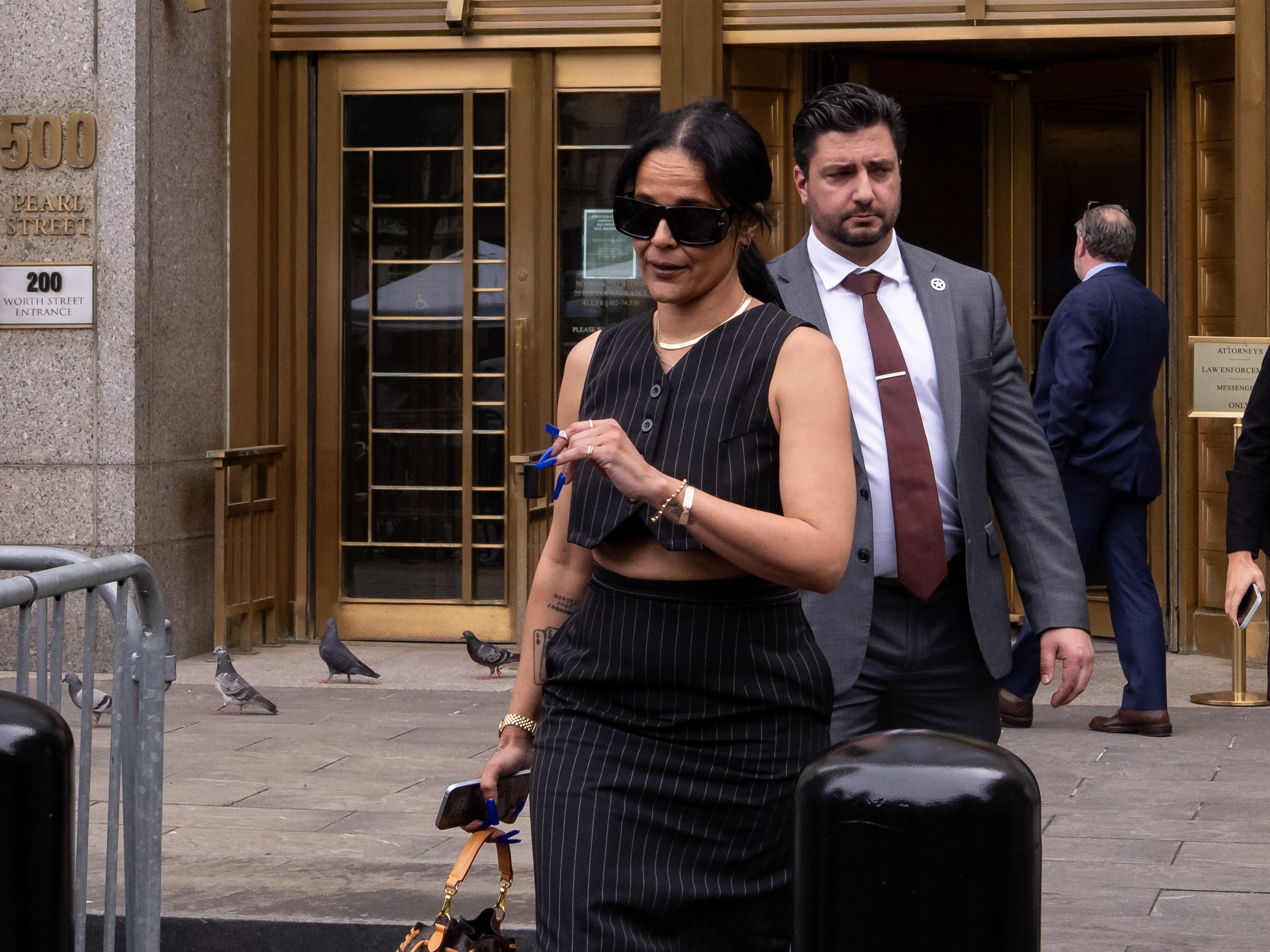 caption: Capricorn Clark, a former employee of Sean Combs, leaves the Manhattan courthouse where she testified that Combs repeatedly threatened her and kidnapped her in during a series of events in 2011 that also involved Kid Cudi and Cassie Ventura, both of whom have also testified.