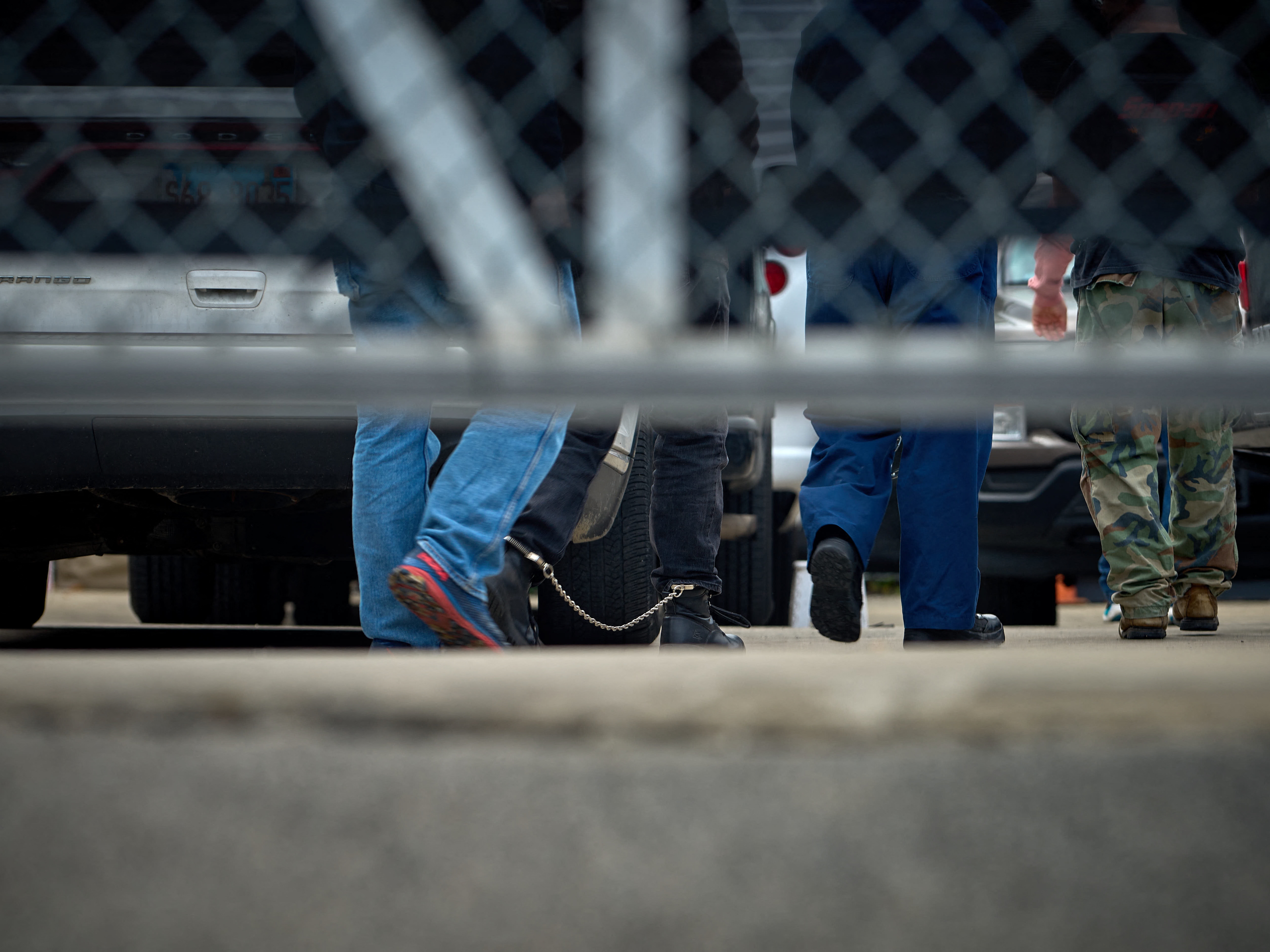 caption: People detained by federal agents walk into a suburban Chicago ICE detention center in Broadview, Ill., on Sept. 19.