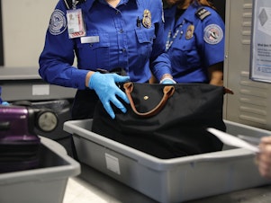 caption: A Transportation Security Administration worker screens luggage at New York's LaGuardia Airport on Sept. 26, 2017. The TSA says it found a record number of firearms at airport security checkpoints last year.