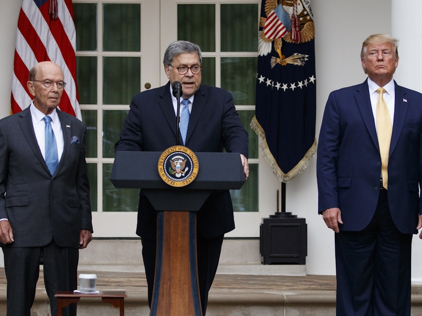 caption: Attorney General William Barr speaks as he stands with President Donald Trump and Commerce Secretary Wilbur Ross during an event about the census in the Rose Garden at the White House earlier this month.