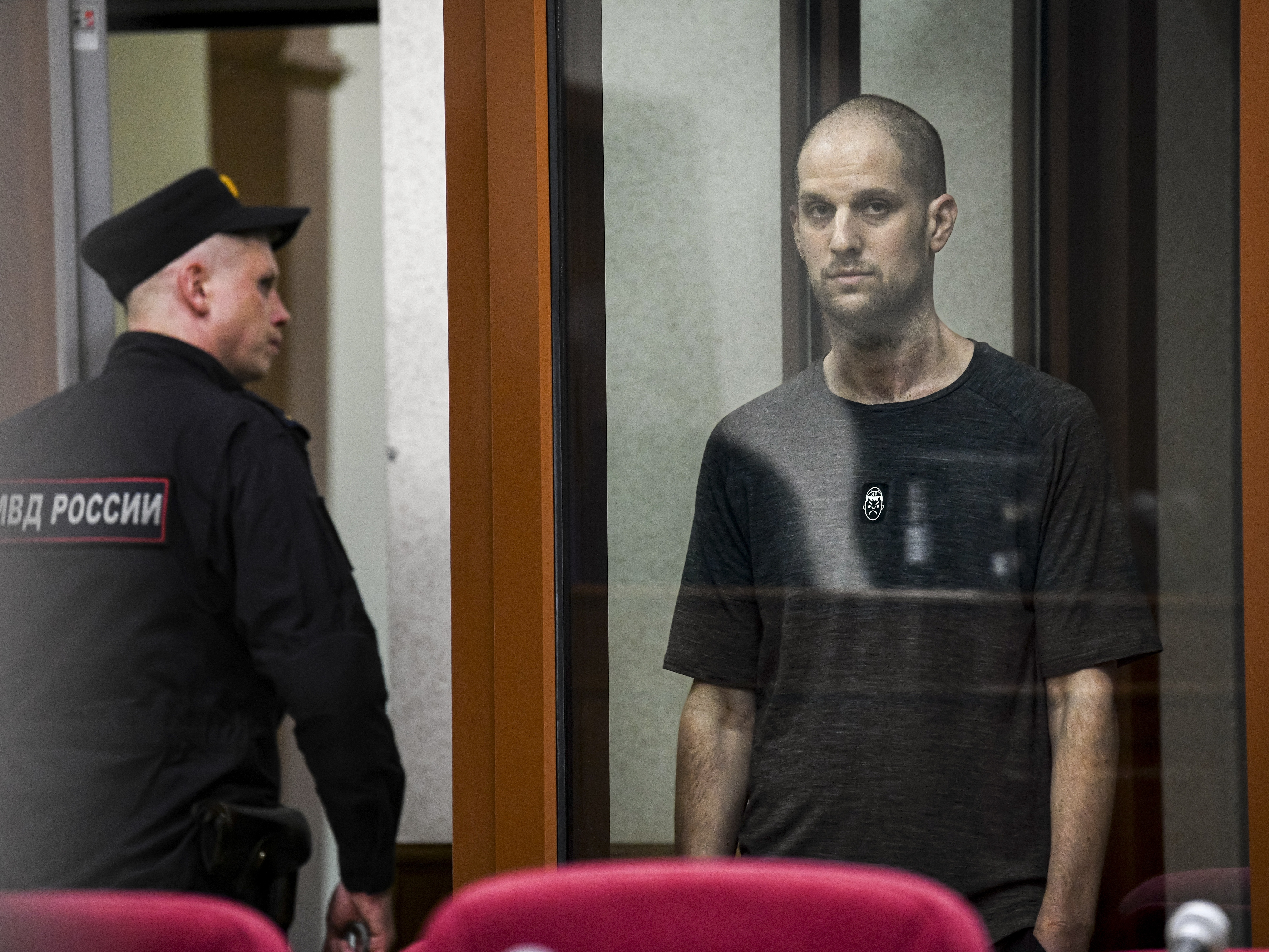 caption: <em>Wall Street Journal</em> reporter Evan Gershkovich stands in a glass cage of a Russian courtroom on  July 19. A Russian court convicted Gershkovich on espionage charges that his employer and the U.S. have rejected as fabricated. He was sentenced to 16 years in prison after a secretive and rapid trial. 