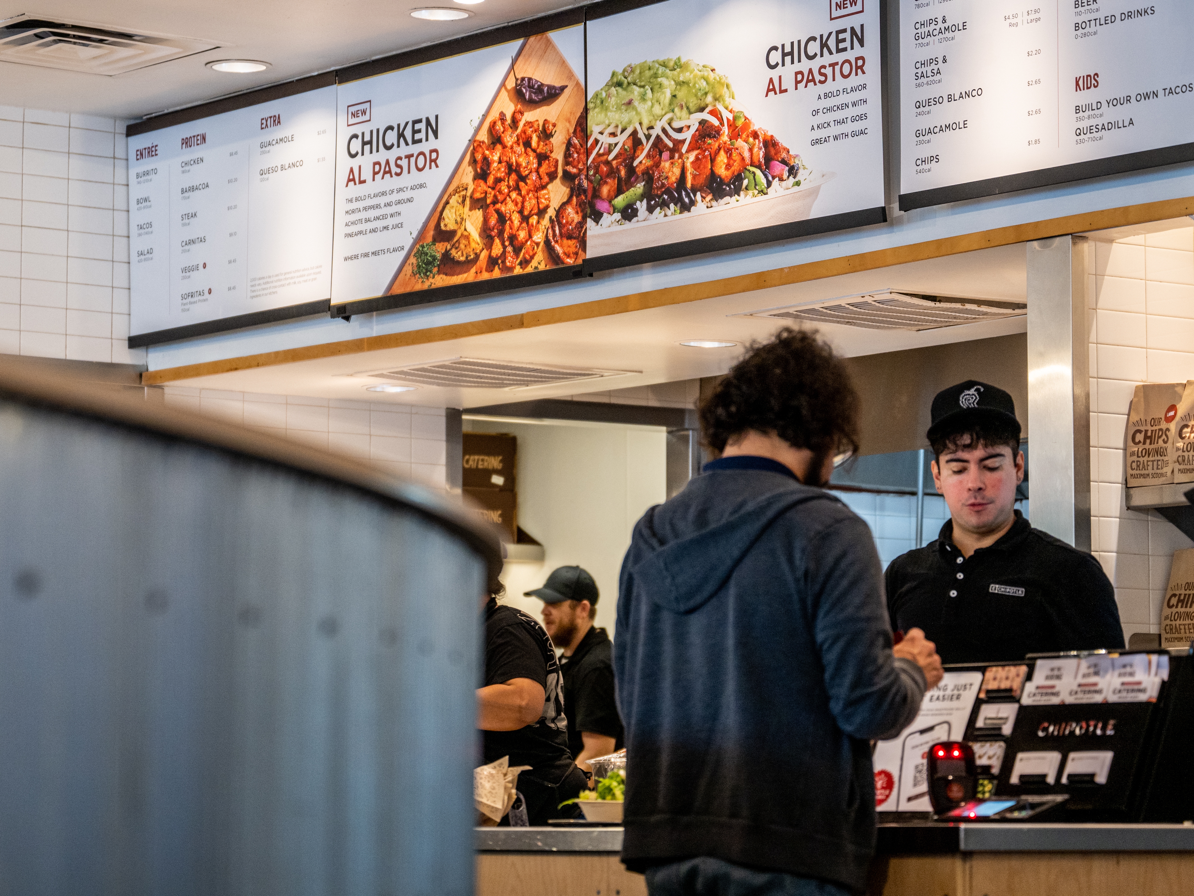 caption: A customer pays for their food at a Chipotle Mexican Grill restaurant in Austin, Texas. Chipotle says its portion sizes have not shrunk, despite complaints shared on social media. 