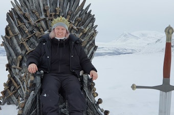 caption: Josefine Wallenå of Sweden sits on the Iron Throne after driving eight hours to find it.