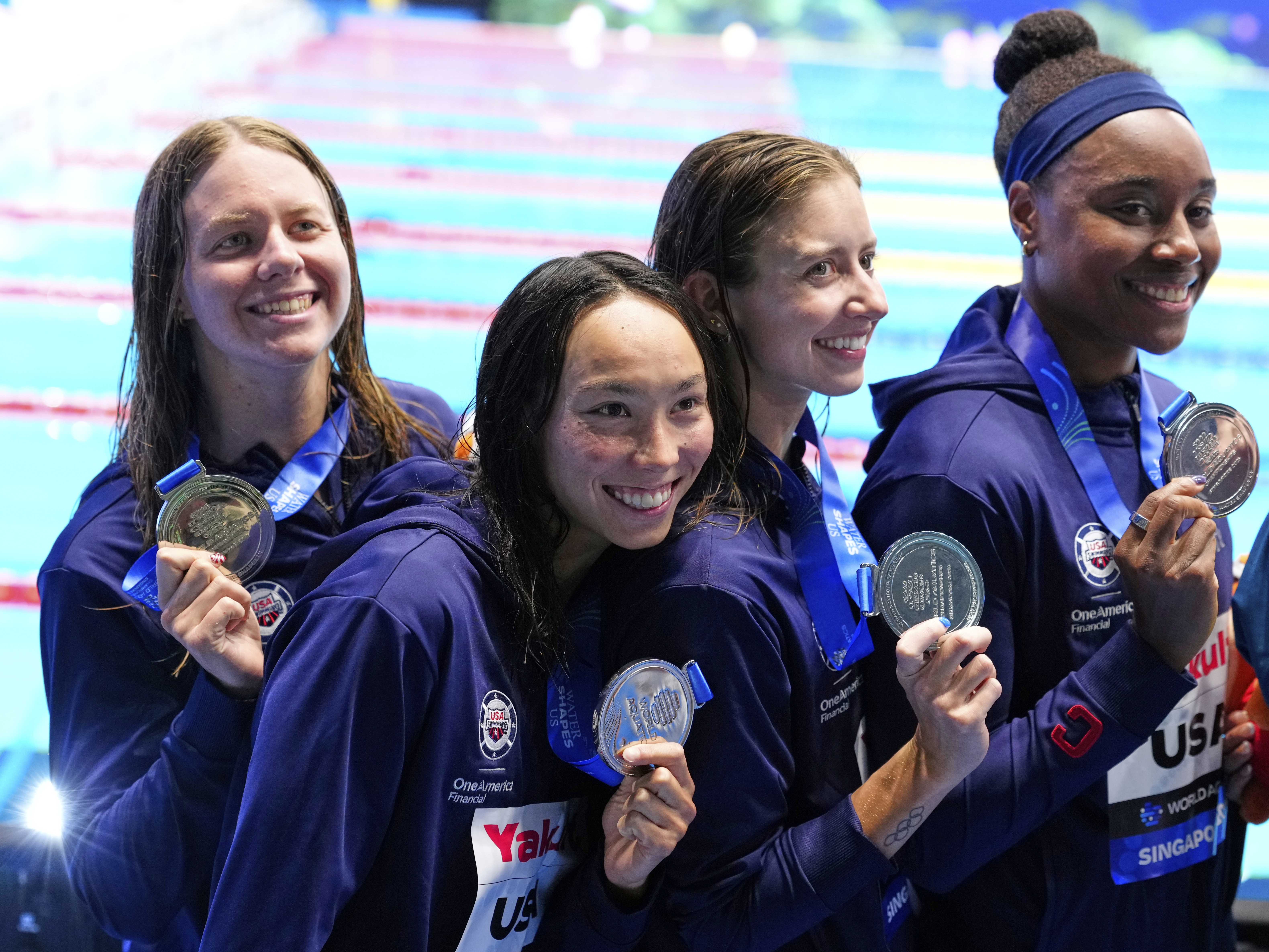 caption: Silver medalist team United States pose after the women's 4x100-meter freestyle final at the World Aquatics Championships in Singapore on Sunday.