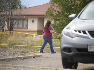 caption: The Return to Nature funeral home is marked off with police tape on Oct. 6 in Penrose, Colo.