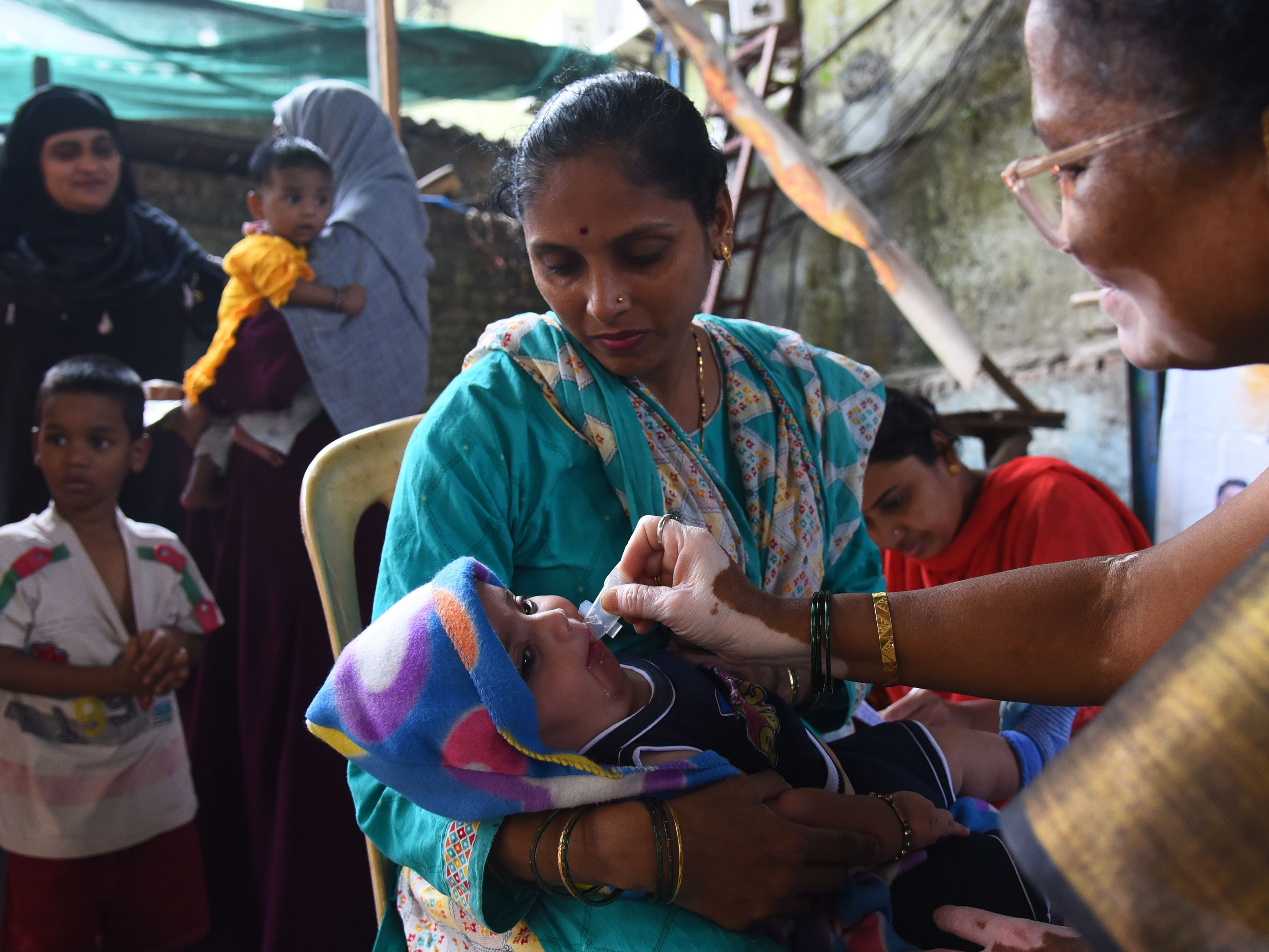 caption: A health care worker administers a measles vaccine to a child at a temporary vaccination camp following an outbreak in Mumbai. India is among the countries that get vaccination support from Gavi, the Vaccine Alliance, whose USAID funding has been terminated.