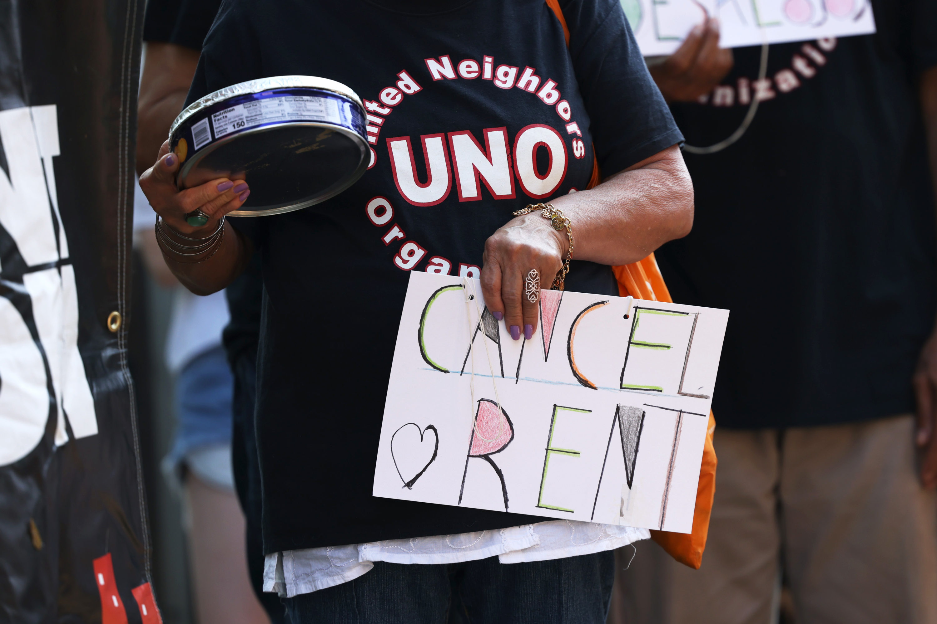 caption: NEW YORK, NEW YORK - AUGUST 10: A demonstrator holds a sign as she listens to speakers during a 'Resist Evictions' rally to protest evictions on August 10, 2020 in New York City. The Right to Counsel NYC Coalition organized a day of action across New York City for tenants who are struggling to pay rent due to the COVID-19 public health crisis. Gov. Andrew Cuomo extended the eviction moratorium which ended on August 6, for an extra 30 days. (Photo by Michael M. Santiago/Getty Images)