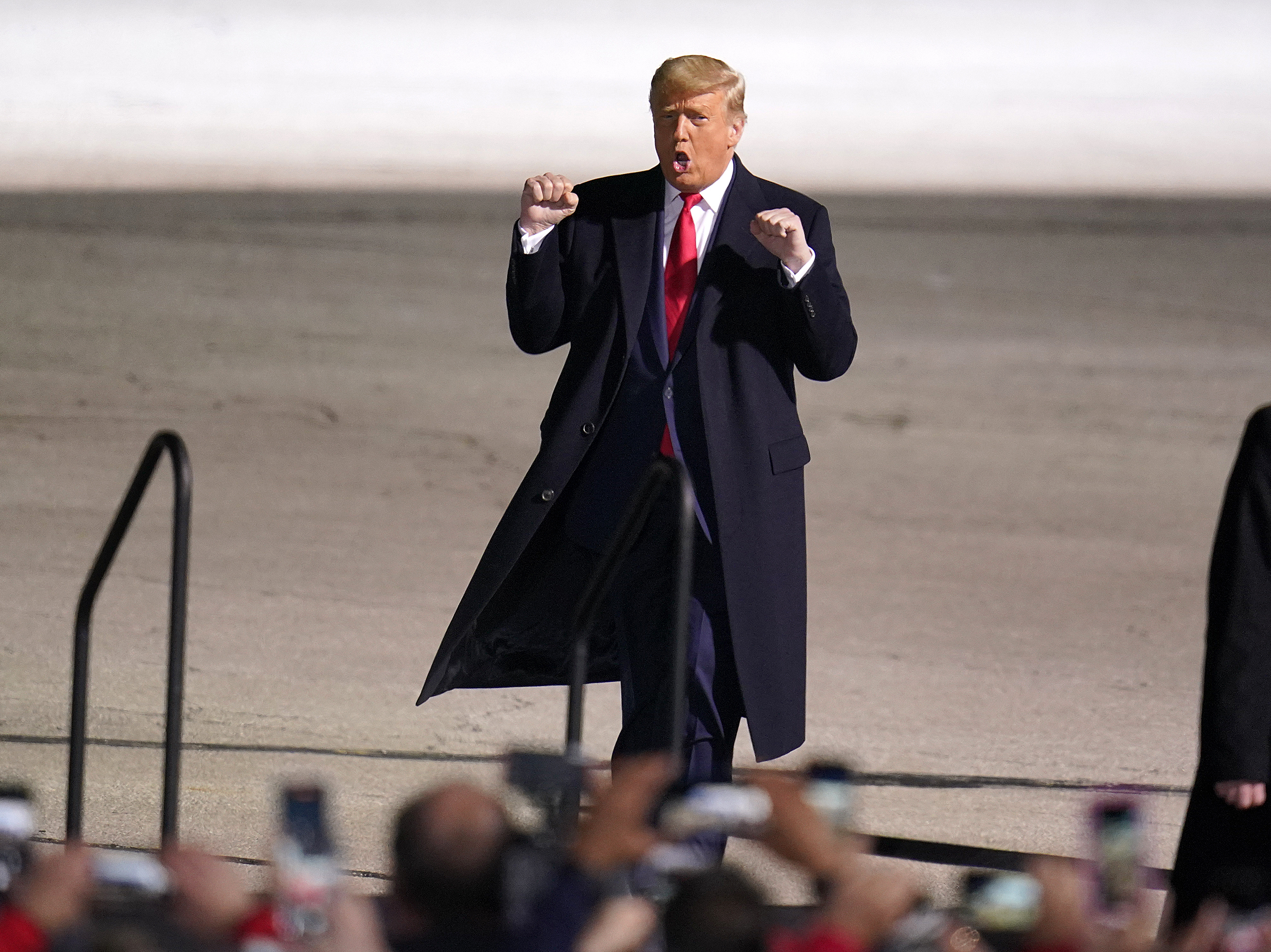caption: President Trump arrives for a campaign rally at Erie International Airport, Tom Ridge Field in Erie, Pa., on Tuesday.
