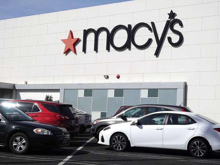 caption: Cars sit parked in front of a Macy's store at Bay Fair Mall on Feb. 27, 2024 in San Leandro, California.