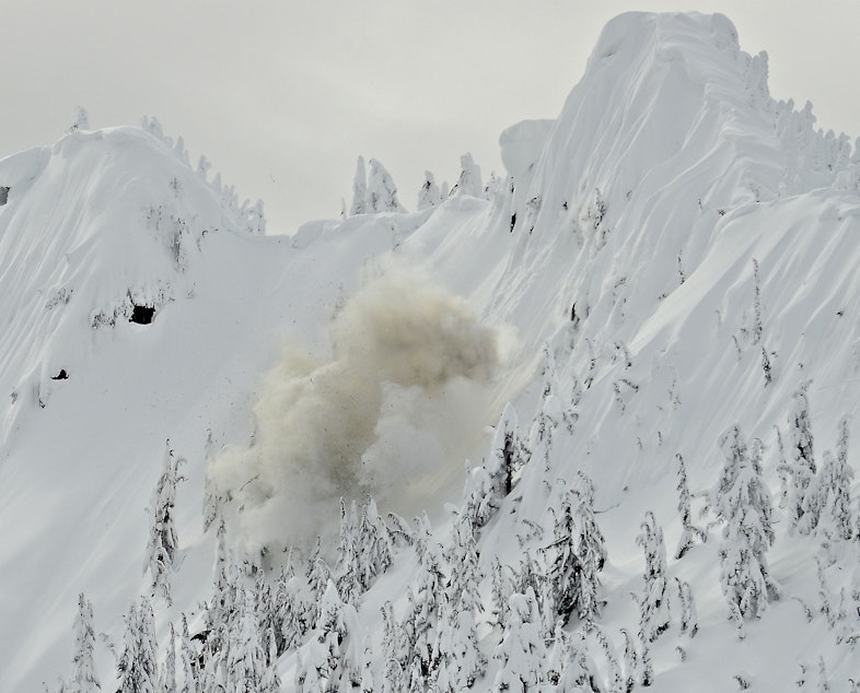 caption: An explosive charge is set off to release an avalanche-prone slope near the Stevens Pass ski area in February 2014.