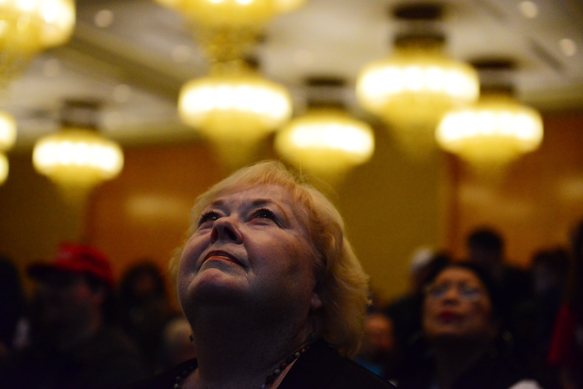 caption: Cheryl Paysen looks at a screen displaying election results during the Washington State Republicans watch party Tuesday in Bellevue.