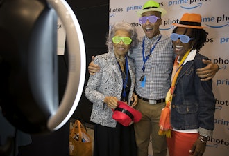 caption: Joseph Jones, an Amazon employee on the marketing team for Amazon channels, takes pictures with his mother, Cathy Jones, right, and his grandmother, Hattie Perry, left, during Amazon's bring your parents to work day on Friday, September 15, 2017.