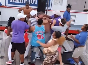 caption: A screenshot from one of the videos of the brawl in Montgomery, Ala., on Saturday. The video shows a fight that broke out between an apparent dock worker and several men who appeared to be parking their pontoon boat in a space reserved for the city's riverboat.