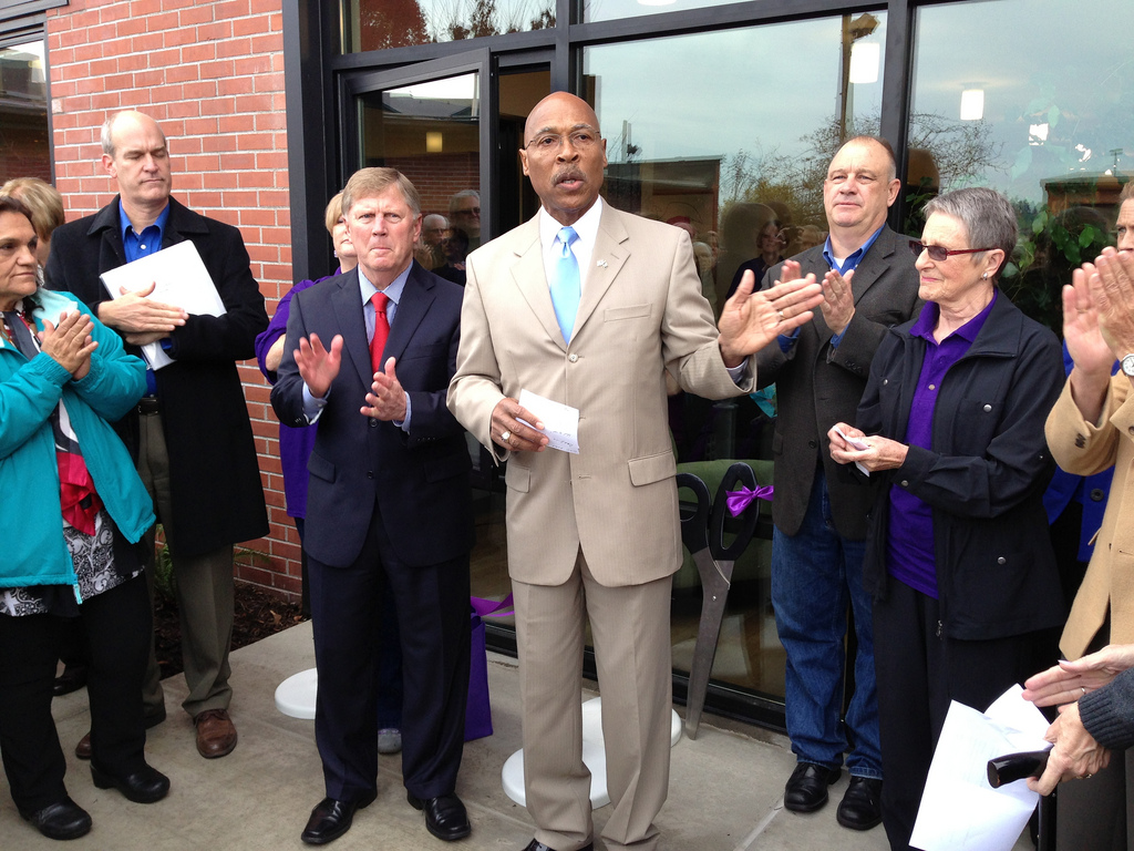 caption: John Lovick and Everett Mayor Ray Stephanson celebrate the opening of a new Domestic Violence Services of Snohomish County facility in Everett on Nov. 6, 2013.
