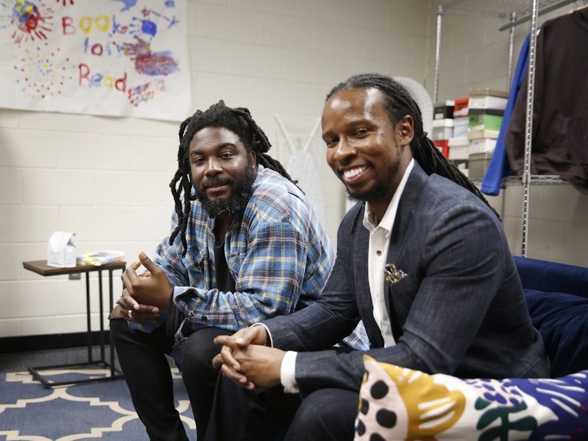caption: Authors Jason Reynolds, left, and Ibram X. Kendi spoke to students at a high school in Washington D.C. about their new book, <em>Stamped: Racism, Antiracism and You.</em>