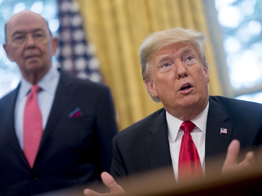 caption: Commerce Secretary Wilbur Ross stands behind President Trump during a bill signing ceremony at the White House in 2018. Ross, who oversees the Census Bureau, approved adding a citizenship question to the 2020 census.