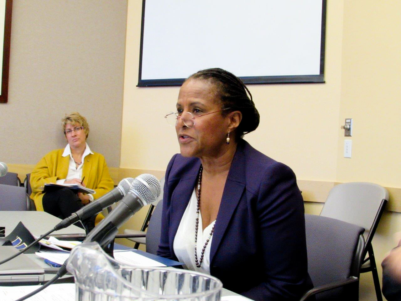 caption: Caryn Mathes, president and general manager of KUOW Public Radio, speaking to the University of Washington Board of Regents.