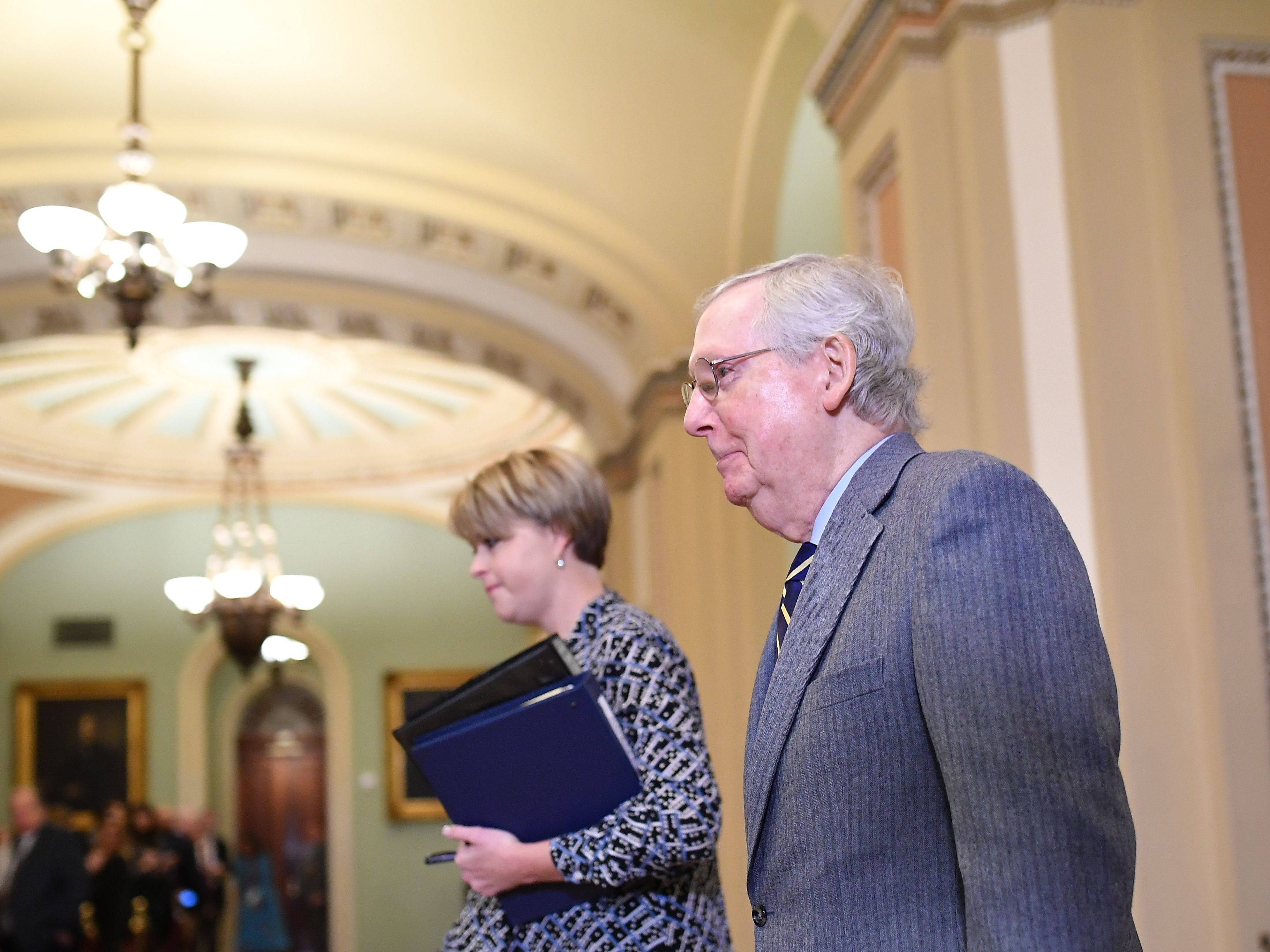 caption: Senate Majority Leader Mitch McConnell walks back to the Senate chamber after a break for the closing arguments in the impeachment trial of President Trump on Monday.