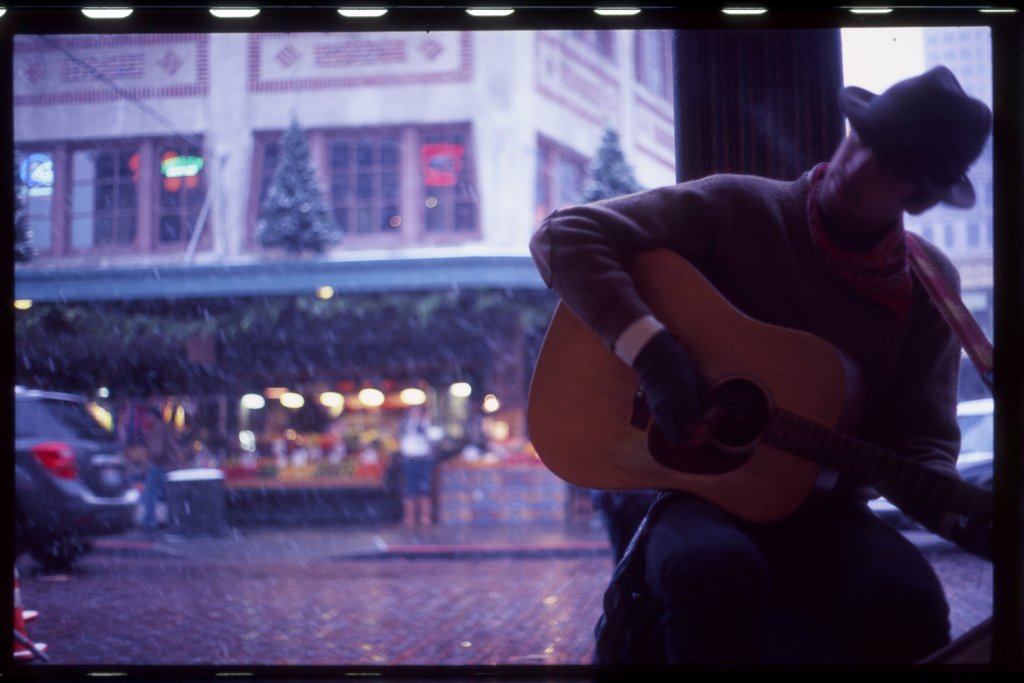 caption: A busker in Pike Place Market.