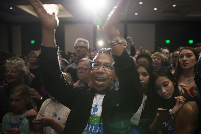 caption: Ben Doko cheers with other supporters as Jenny Durkan gives a speech on Tuesday, November 7, 2017, at The Westin in Seattle.
