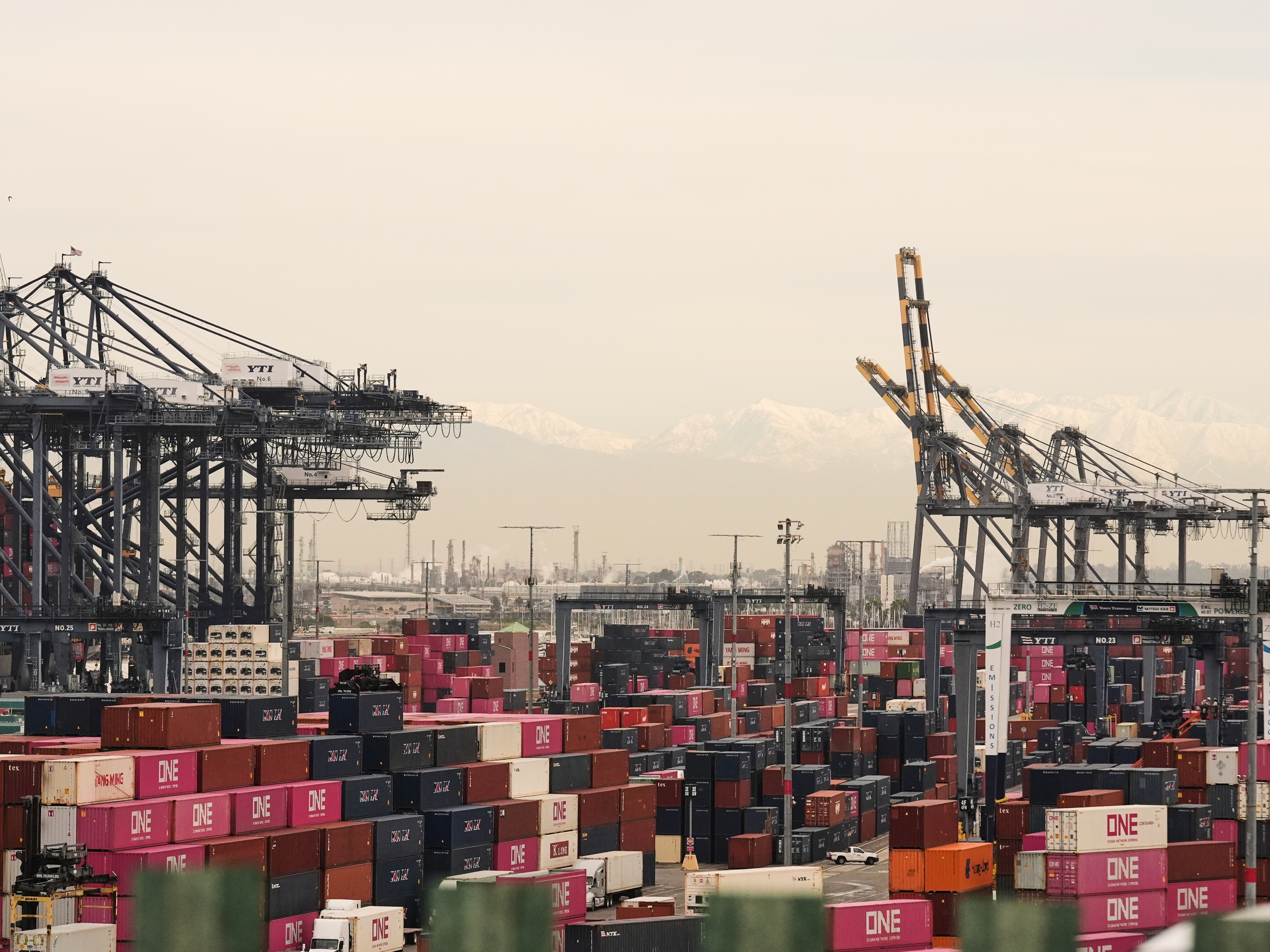 caption: Containers are stacked at the Port of Los Angeles on Friday.
