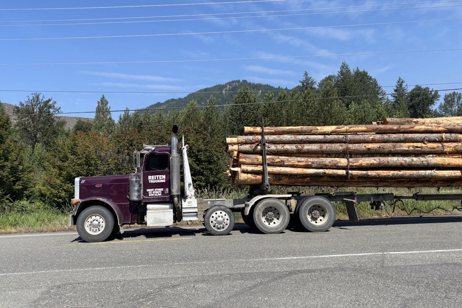 caption: A logging truck thunders past the Hampton Mill in Morton, Washington.