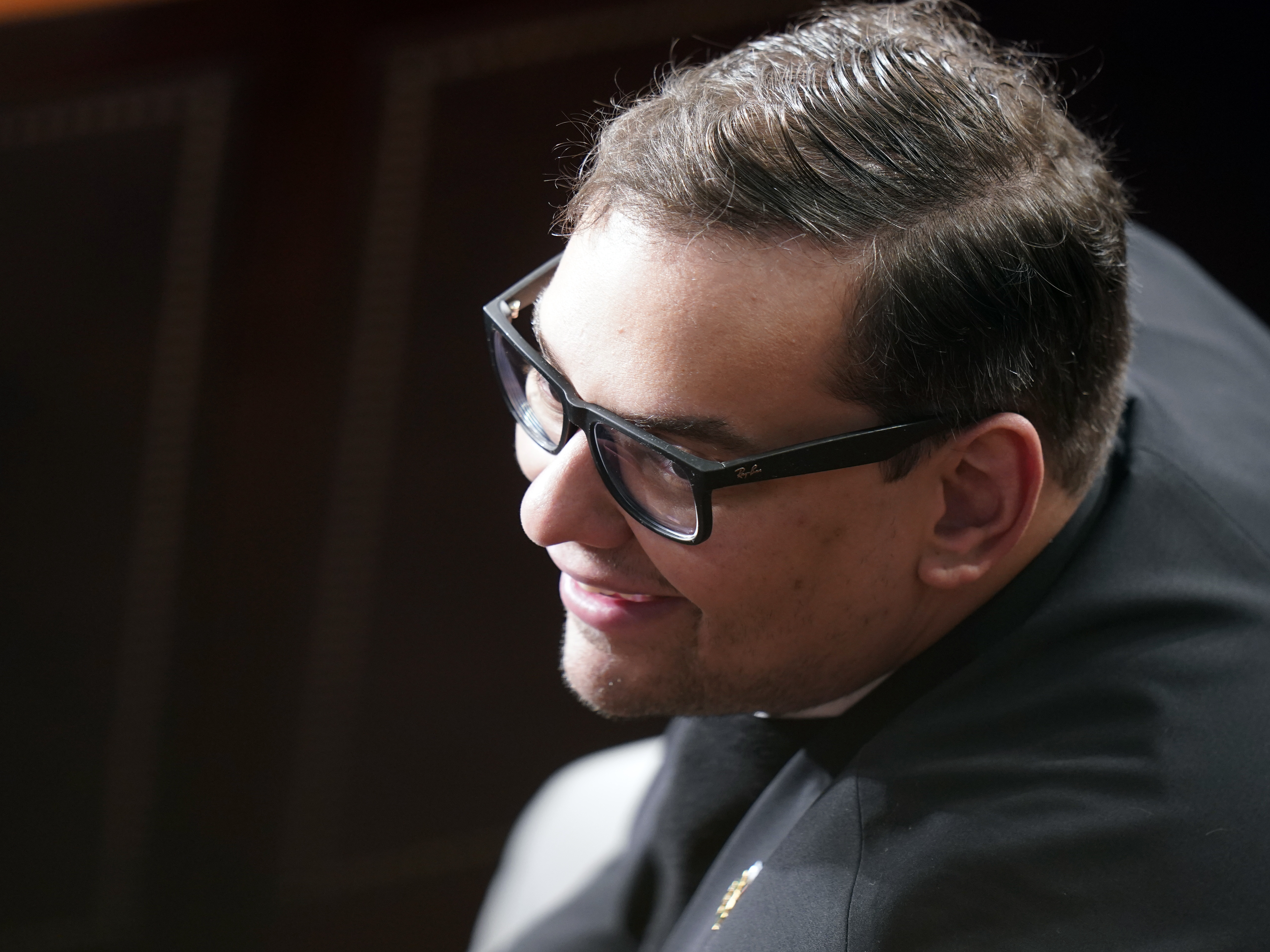 caption: Rep. George Santos, R-N.Y., is shown listening as Republicans try to elect Rep. Mike Johnson, R-La., to be the new House speaker, at the Capitol in Washington, Wednesday, Oct. 25, 2023.
